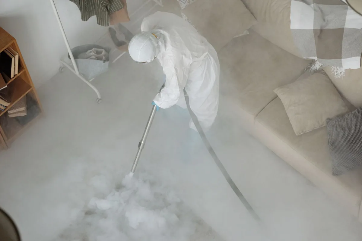 Biohazard cleanup technician in protective equipment, Durham, OR